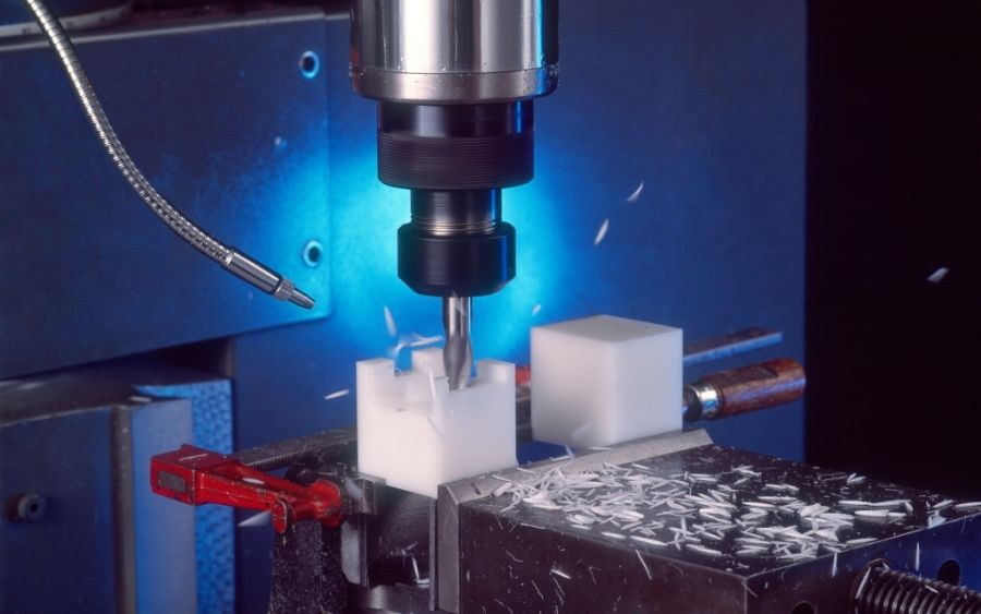 Plastic being machined in a CNC machine